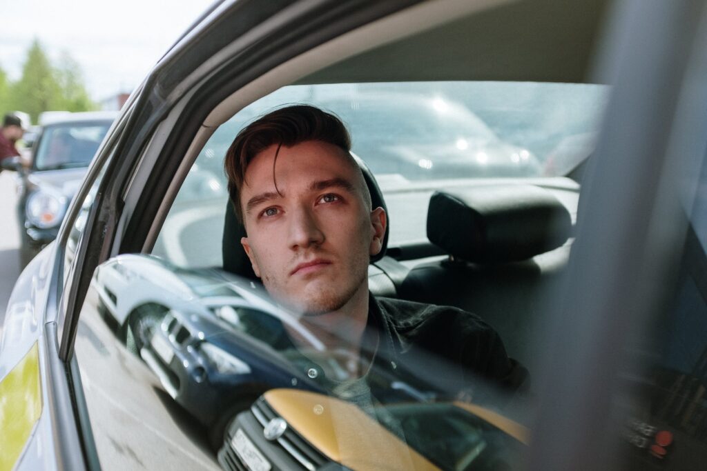 Man riding a taxi looking at the sky